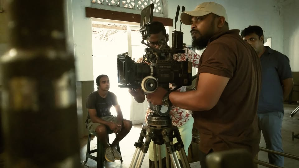 Camera crew preparing an indoor shot during the visual production