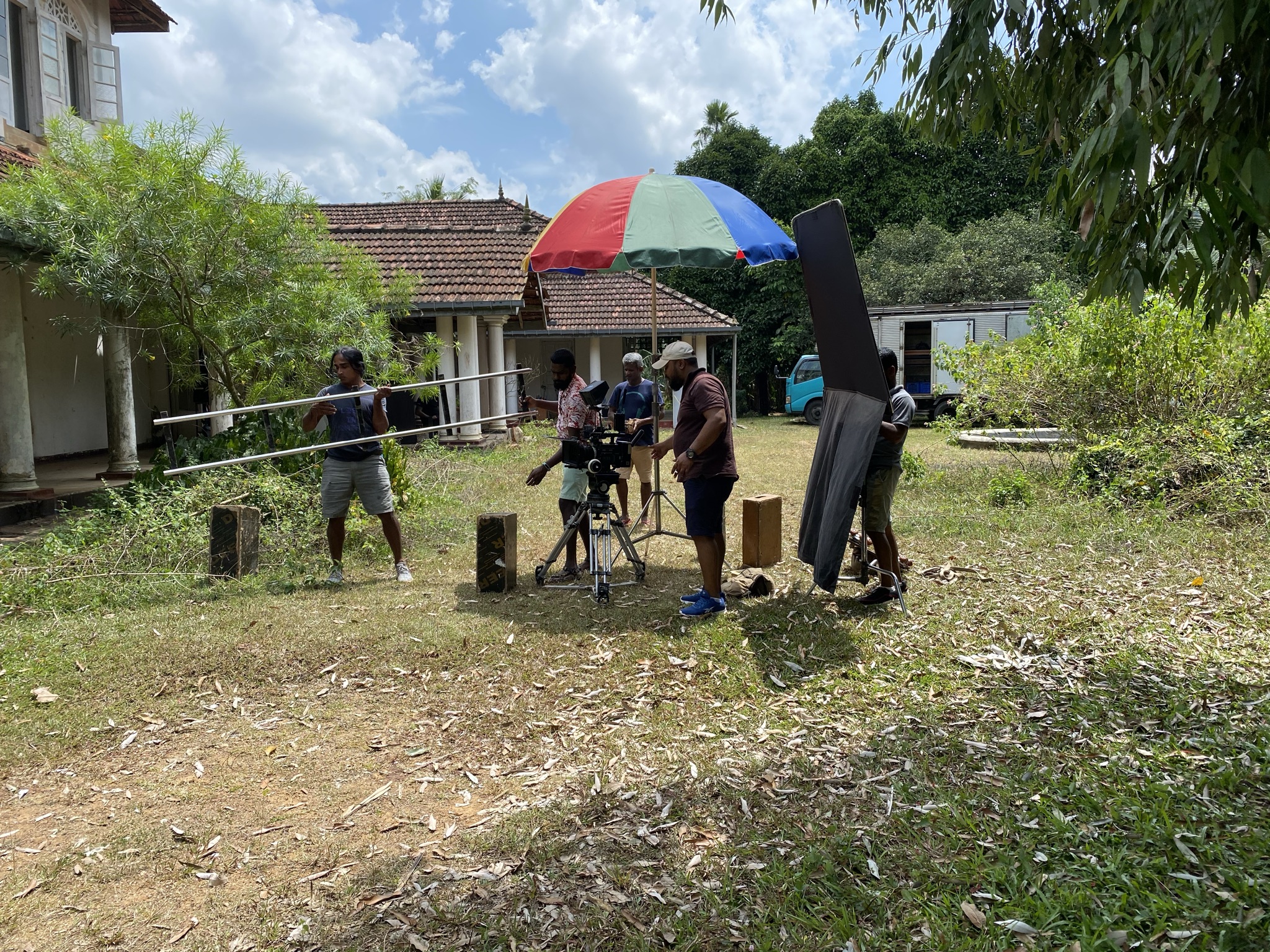 Film crew setting up an outdoor scene on location